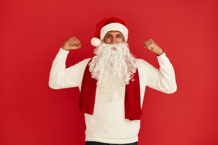 Santa Claus Showing Biceps. Portrait of Confident Proud Man Showing Bicepsの写真素材