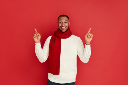 Smiling Man Pointing Hand. Positive Multiracial Guy Pointing Awayの写真素材
