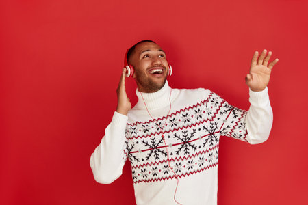 Winter Man Listening Music. Multiracial Man Listening Song Wearing Headphonesの写真素材