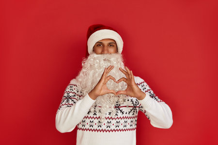 Santa Claus Showing Heart Shape Gesture. Positive Man Showing Romantic Gestureの写真素材