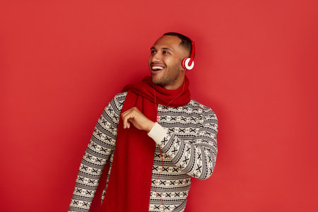 Winter Man Listening Music. Positive Multiracial Man Listening Song Headphonesの写真素材