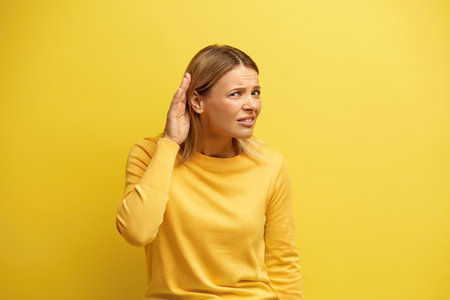 Blonde Woman Trying to Hear Isolated. Confused Girl Having Hearing Problemsの写真素材