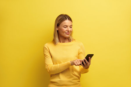 Happy Woman Holding Smartphone Isolated. Caucasian Girl Messaging Cellphoneの写真素材