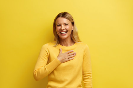 Blonde Woman Smiling Camera. Cheerful Girl Wearing Sweater Smiling Sincerelyの写真素材