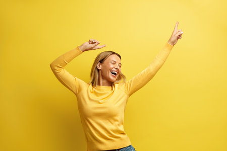 Excited Woman Rejoicing Isolated. Overjoyed Girl Standing with Raised Handsの写真素材