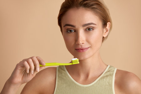 Healthy White Teeth. Portrait Of Woman Holding Toothbrush With Toothpasteの写真素材