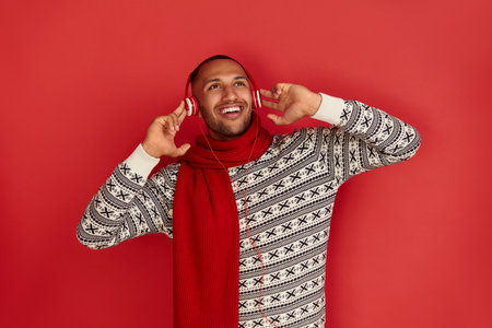 Winter Man Listening Music. Positive Multiracial Man Listening Song Headphonesの写真素材