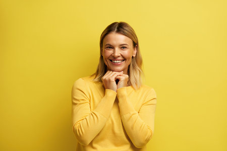 Surprised Woman Rejoicing Success. Portrait Blonde Girl Celebrating Win Indoorの写真素材