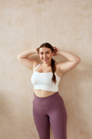 Size Plus Woman Relaxing After Yoga. Smiling Female Posing After Yoga Sessionの写真素材