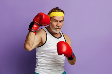 Strong Man Boxing In Gloves. Portrait of Senior Man Trainingの写真素材