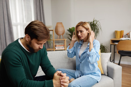 Couple Having Argument At Home. Angry Wife Shouting At Husband Of Problemの写真素材