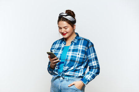 Happy Woman Messaging Smartphone Isolated. Plus Size Girl Messaging Cellphoneの写真素材