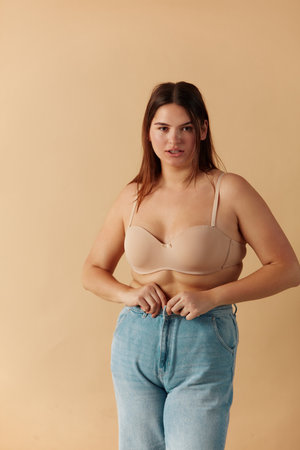 Plus Size Woman in Jeans. Sexy Overweight Woman Fastening Jeansの写真素材