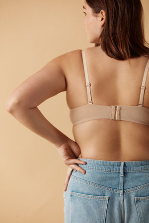 Plus Size Woman. Back View Of Happy Full Figured Woman Posing In Beige Lingerieの写真素材