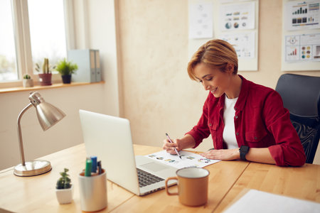 Businesswoman Working Office. Positive Lady Examining Documentsの写真素材