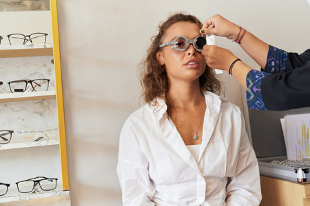 Eye Exam. Woman In Glasses Checking Eyesight At Clinic