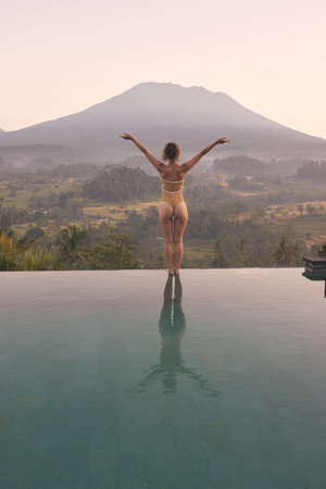 Woman Enjoying Sunrise at Agung Volcano, Bali.の写真素材