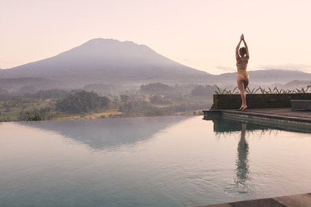 Woman Sunrise Yoga for Spiritual Balance at Agung Volcano. Bali Indonesia.の写真素材