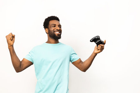 Joyful African American Man Holding Game Controller on Whiteの写真素材