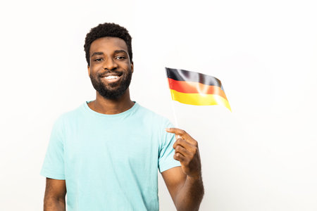 Cheerful African American Man Holding German Flag Isolated on Whiteの写真素材