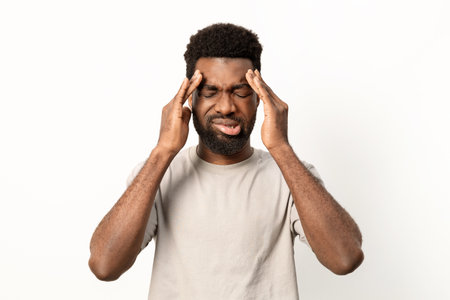 Man Experiencing Headache or Stress Against White Backgroundの写真素材