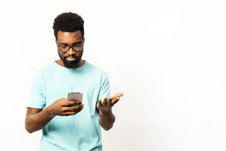 Afro American Man Using Smartphone with Various Emotions Isolated on Whiteの写真素材