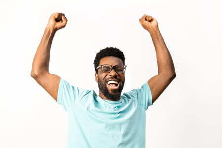 Excited African American Man Celebrating Success on White Backgroundの写真素材
