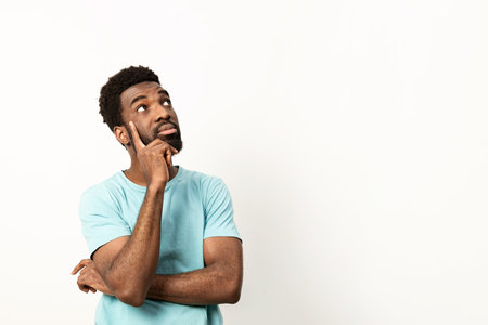 Thoughtful Man Pondering Ideas in Casual Settingの写真素材
