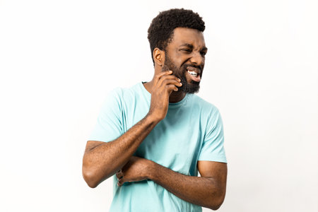 African American Man Laughing Joyfully in Casual Attire Isolated on Whiteの写真素材