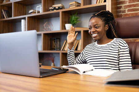 Cheerful African American Woman Enjoying Video Call at Homeの写真素材
