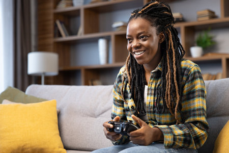 Joyful African American Woman Playing Video Games at Homeの写真素材
