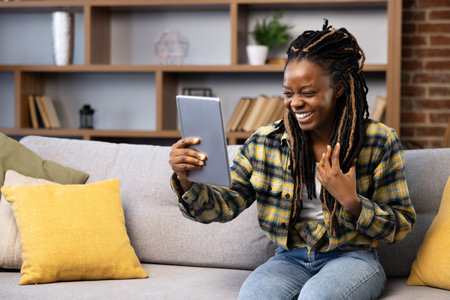 Happy Afro American Woman Enjoying Video Call at Homeの写真素材