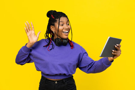 Woman Waving Hello During Video Call On Her Tabletの写真素材