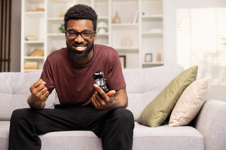 Young Man Playing Video Games on Couch at Home