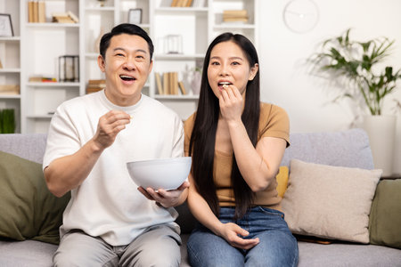 Couple Enjoying Snack Time Together at Homeの写真素材