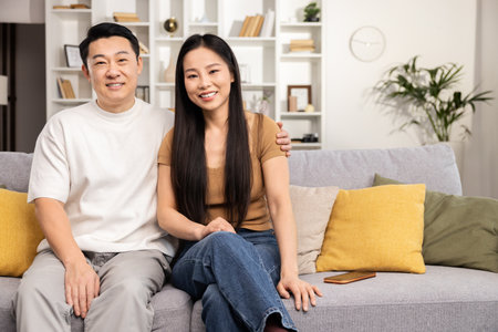 Asian Couple Planning Finances and Shopping Online at Homeの写真素材