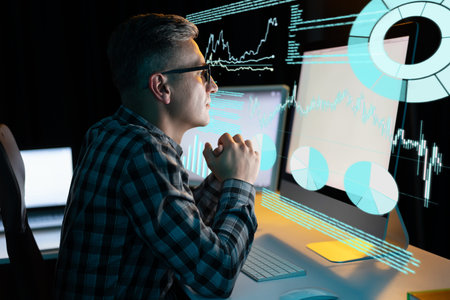 Man Analyzing Data on Computer with Graphs and Charts in Background