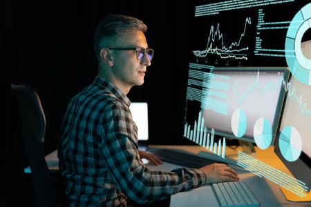Man Analyzing Graphs and Data on Multiple Computer Screens