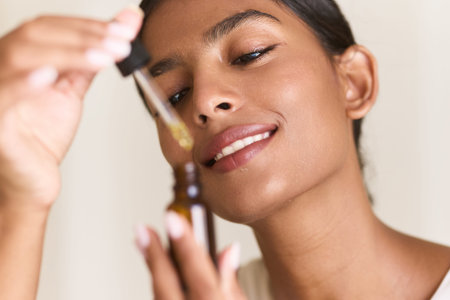 Woman Enjoying Skincare Ritual With Serum Dropper Bottle Close-Up