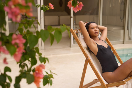 Body Care. Relaxing by the Poolside with Sun-Kissed Glow and Tranquilityの写真素材