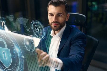 Cybersecurity Professional Using Futuristic Interface in Modern Office Setting at Nightの写真素材