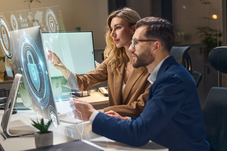 Technology Professionals Analyzing Cybersecurity Data on a Futuristic Digital Interface Screenの写真素材