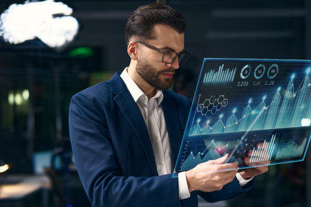 Professional Analyzing Digital Data on a Futuristic Screen in a Modern Officeの写真素材