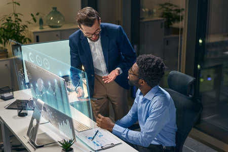 Business Team Analyzing Data With Holographic Technology in a Modern Office Settingの写真素材