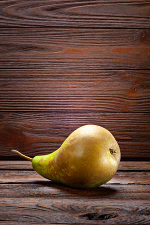 One pear on a dark wooden background. Organic foods, healthy nutrition.の写真素材