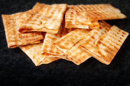 Hot crispy cookies piled on black marble. Freshly baked cookies. Selective soft focus.