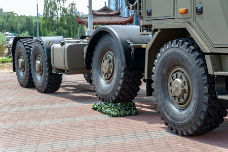 Military truck. Close-up of a wheel of a military truck TATRA at the international exhibition ARMS AND SECURITY - 2021. Selective focus. Kiev. Ukraine - June 18, 2021.のeditorial素材