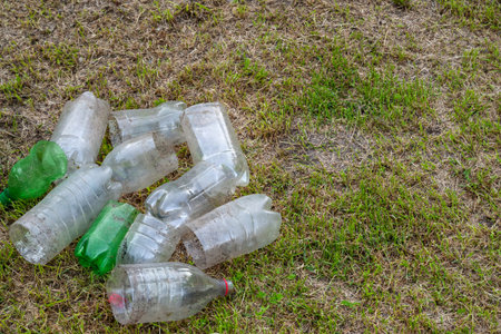 Plastic bottles. A pile of old dirty cutting plastic bottle on dry grass. The concept of...
