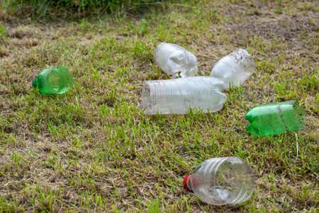 Plastic bottles. Heap of used cut old dirty plastic bottles on dry grass in the garden....