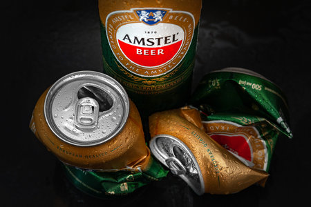Beer cans. Wet crumpled AMSTEL beer cans with drops on a dark background, close-up. AMSTEL is a world famous brand from the Netherlands. Selective soft focus. Kiev. Ukraine. June-26.2021のeditorial素材